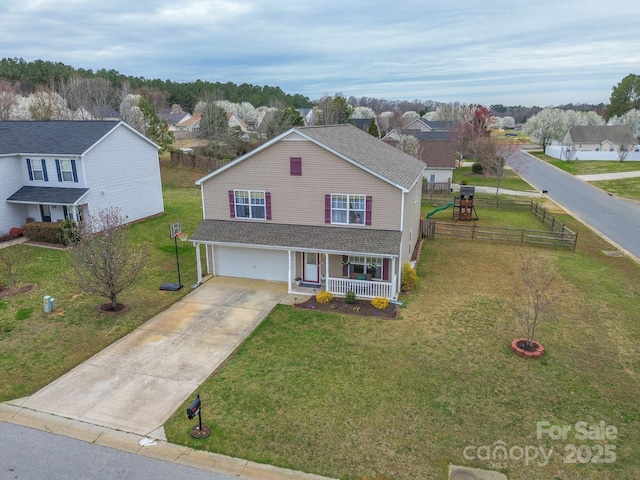 traditional-style house with covered porch, driveway, a front lawn, and a garage