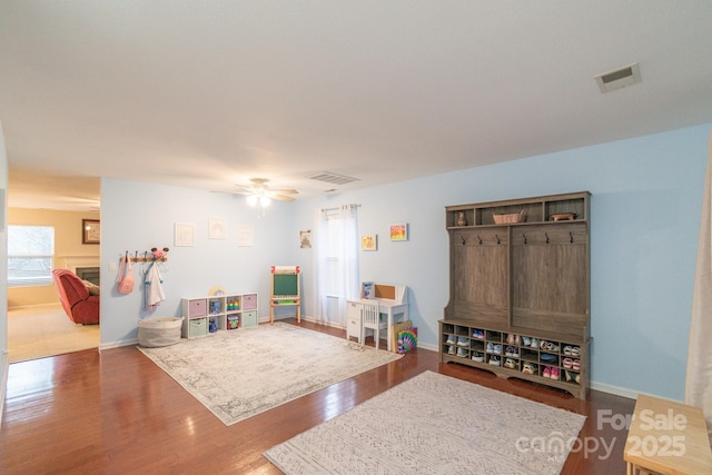 game room with ceiling fan, visible vents, baseboards, and wood finished floors