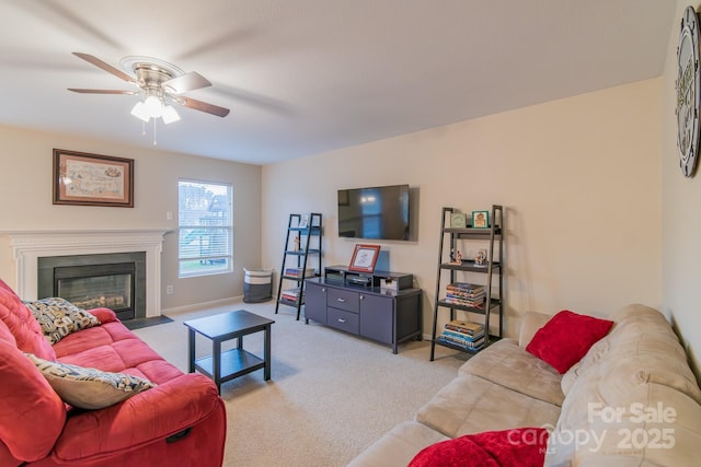 living area with light carpet, a fireplace with flush hearth, baseboards, and a ceiling fan