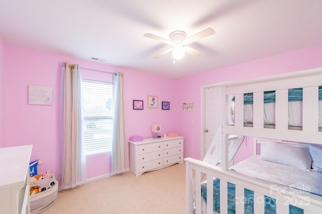 bedroom with ceiling fan, baseboards, visible vents, and light carpet