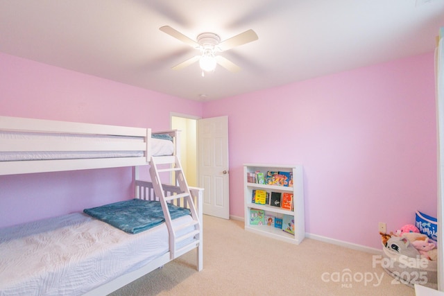 carpeted bedroom featuring baseboards and a ceiling fan