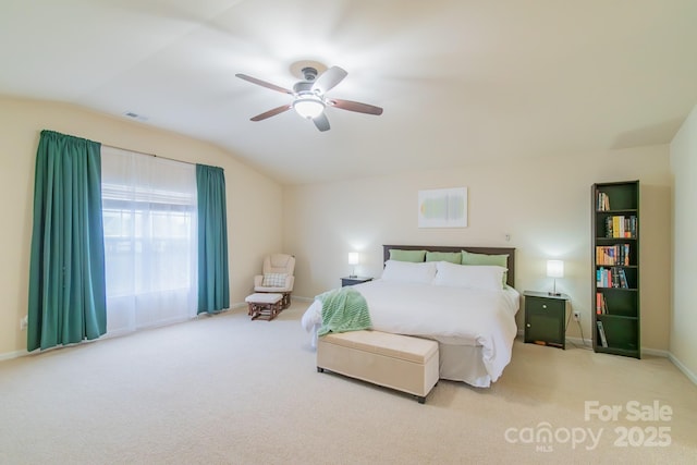 carpeted bedroom with visible vents, baseboards, ceiling fan, and vaulted ceiling