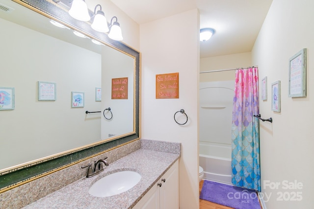 bathroom featuring visible vents, toilet, vanity, and shower / tub combo with curtain