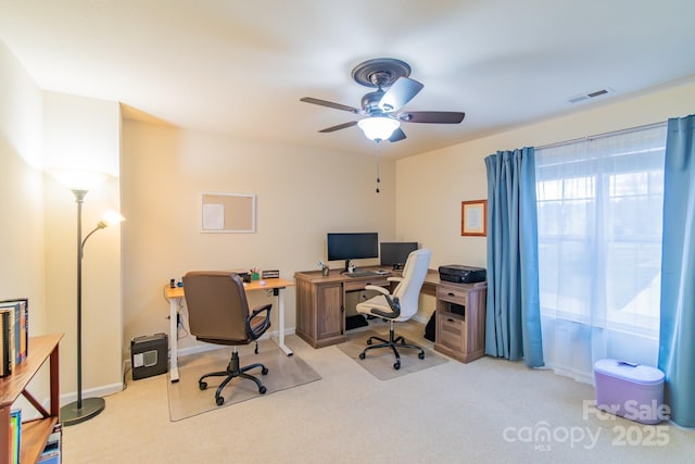 office area featuring carpet, a ceiling fan, visible vents, and baseboards