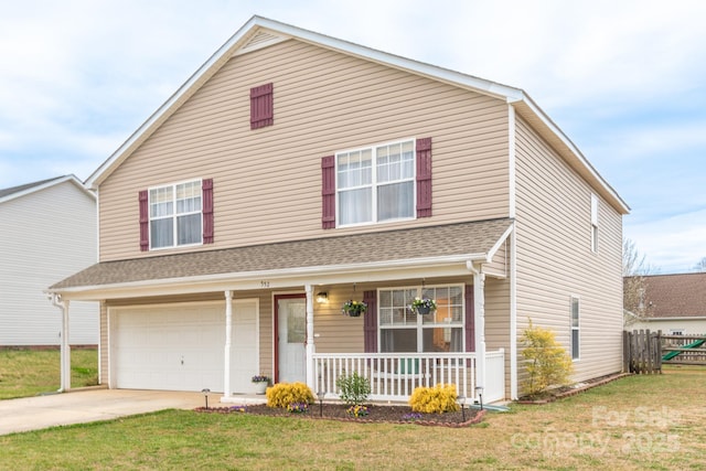 traditional-style house with a front lawn, covered porch, concrete driveway, and an attached garage