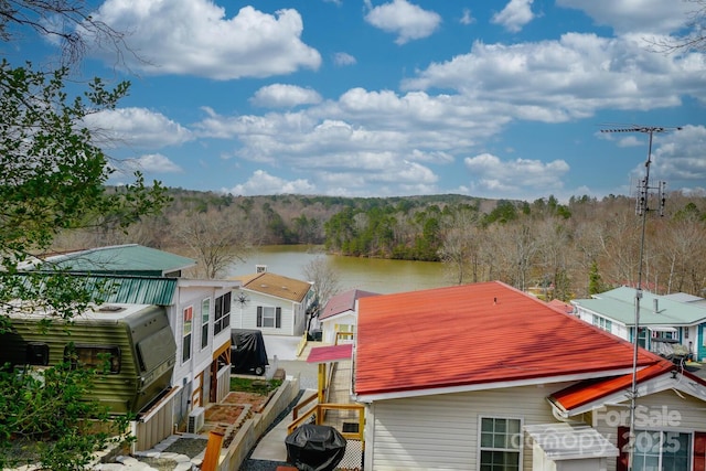 exterior space with a view of trees and a water view