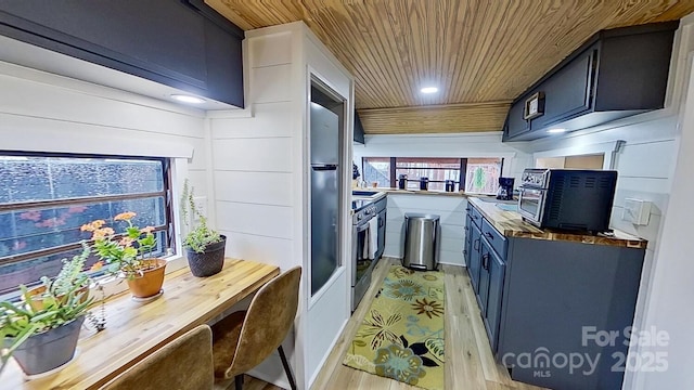 kitchen featuring oven, light wood-style flooring, blue cabinetry, recessed lighting, and wood ceiling