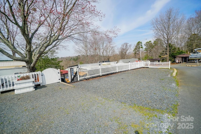 view of yard with a fenced front yard and a gate