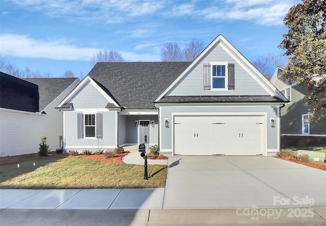 view of front of home with concrete driveway, a front yard, and roof with shingles