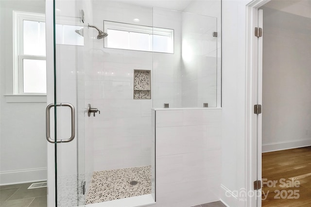 full bath featuring visible vents, baseboards, and a stall shower