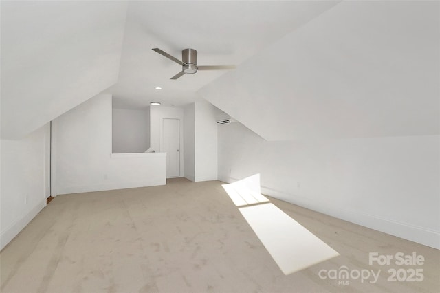 additional living space featuring carpet flooring, lofted ceiling, baseboards, and a ceiling fan