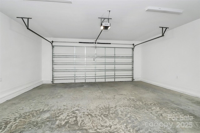 garage with baseboards and a garage door opener