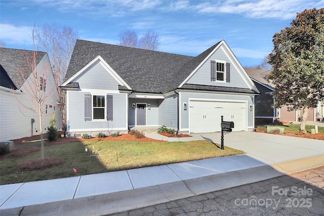 view of front of home with a front yard, an attached garage, driveway, and roof with shingles