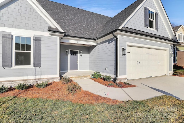 view of front of house with concrete driveway and a shingled roof