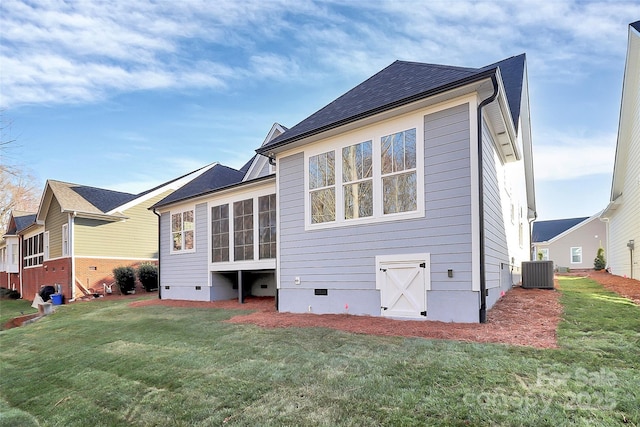 back of property featuring central air condition unit, a lawn, and crawl space