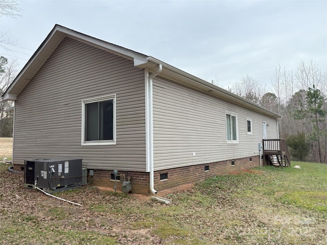 view of home's exterior with crawl space and central air condition unit