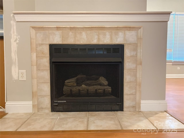 details featuring a fireplace and baseboards