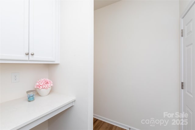 interior space featuring wood finished floors and baseboards