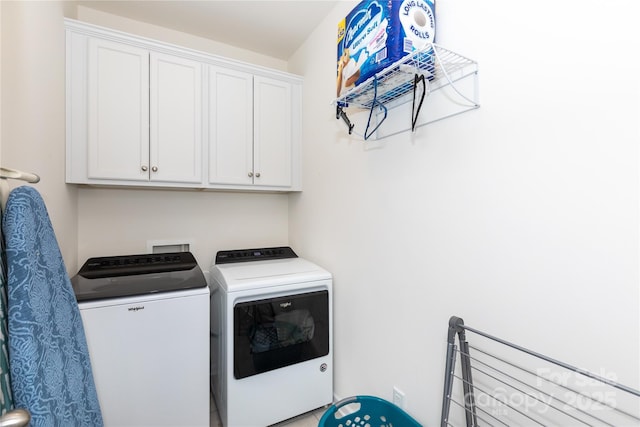 washroom with cabinet space and washing machine and dryer