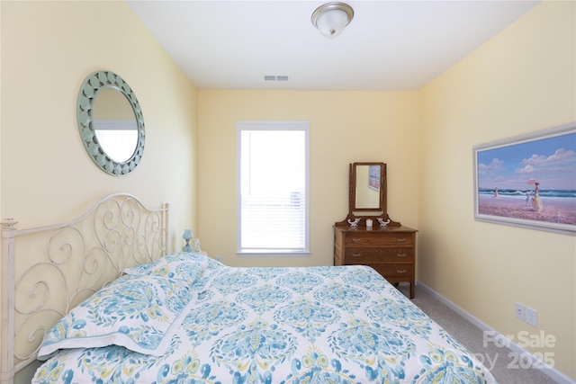 carpeted bedroom featuring visible vents and baseboards