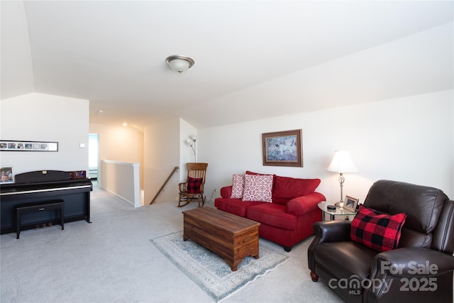 carpeted living room with lofted ceiling