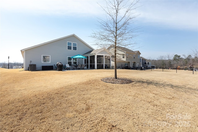 back of house with cooling unit, a patio area, a lawn, and fence