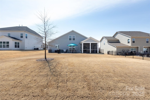 view of yard with fence and a sunroom