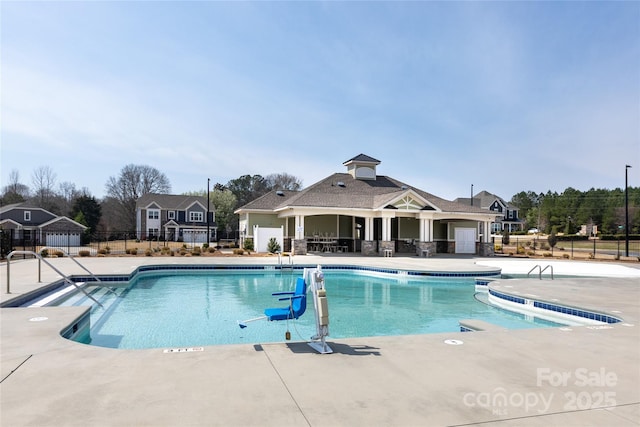 pool featuring a patio area and fence