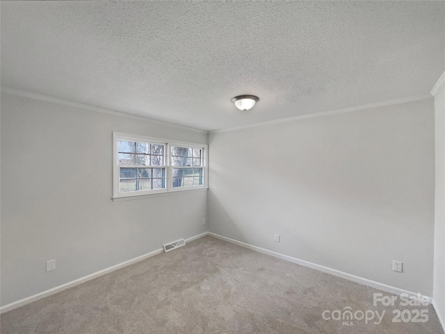 carpeted empty room featuring visible vents, baseboards, a textured ceiling, and ornamental molding