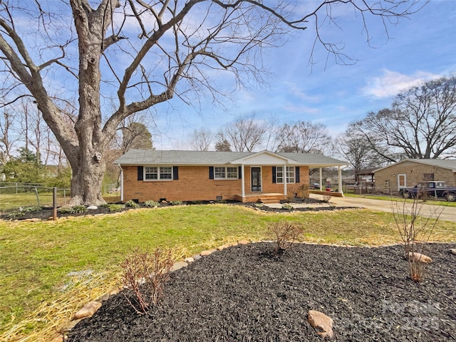 view of front facade featuring brick siding, a front lawn, fence, a chimney, and crawl space