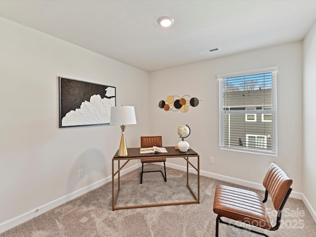 carpeted office space with visible vents and baseboards