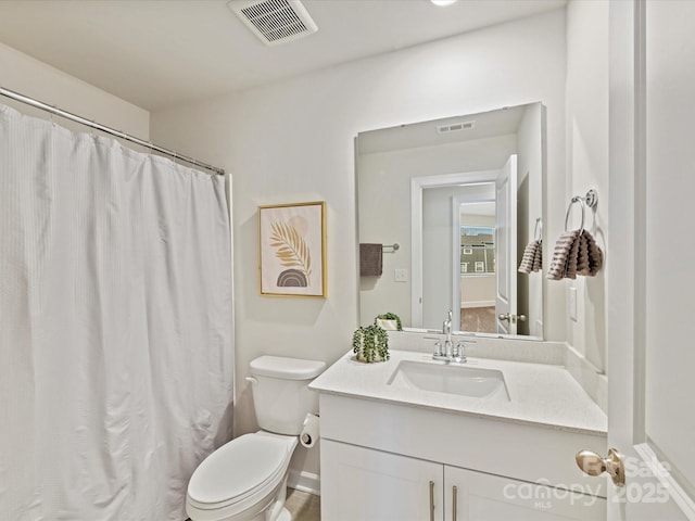 bathroom featuring visible vents, toilet, vanity, and a shower with curtain