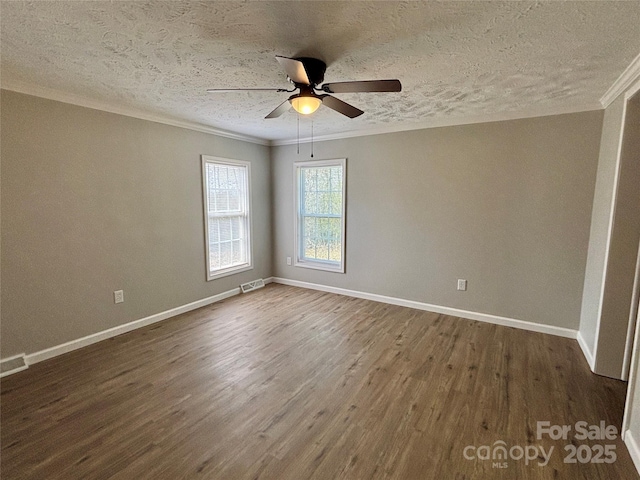 unfurnished room with dark wood-style flooring, baseboards, a ceiling fan, and ornamental molding