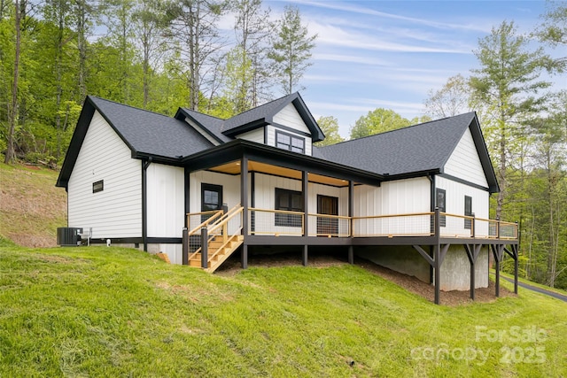 82 Arrowood Rd, Weaverville, NC 28787 - rear view of house with cooling unit, a lawn, roof with shingles, and a wooden deck