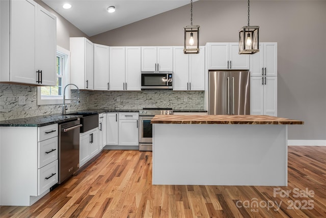 82 Arrowood Rd, Weaverville, NC 28787 - kitchen with stainless steel appliances, butcher block counters, lofted ceiling, a sink, and a kitchen island
