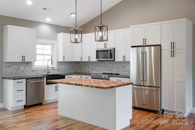 82 Arrowood Rd, Weaverville, NC 28787 - kitchen featuring stainless steel appliances, wood counters, a sink, a kitchen island, and decorative backsplash