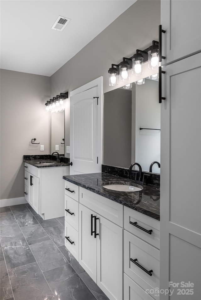 82 Arrowood Rd, Weaverville, NC 28787 - full bathroom with marble finish flooring, two vanities, and baseboards