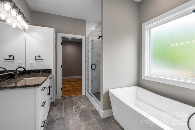 82 Arrowood Rd, Weaverville, NC 28787 - full bath with a stall shower, a soaking tub, vanity, baseboards, and marble look tile flooring