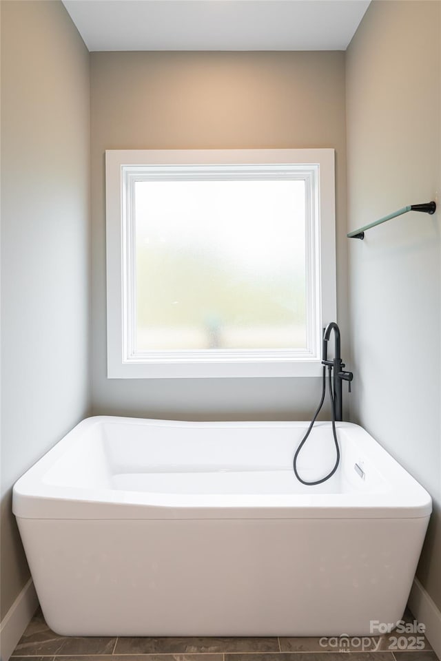 82 Arrowood Rd, Weaverville, NC 28787 - full bathroom with a freestanding tub and baseboards