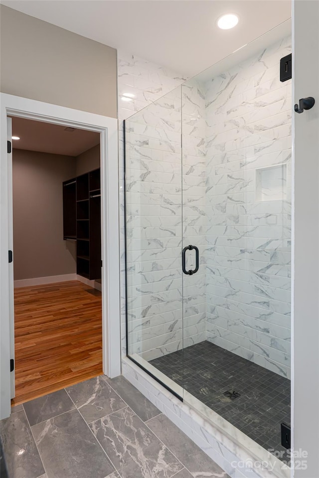 82 Arrowood Rd, Weaverville, NC 28787 - bathroom featuring marble look tile flooring, a stall shower, recessed lighting, and baseboards