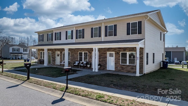 view of front of house featuring a porch and a front yard