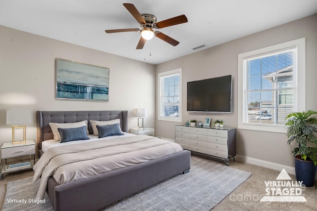 carpeted bedroom featuring visible vents, ceiling fan, and baseboards