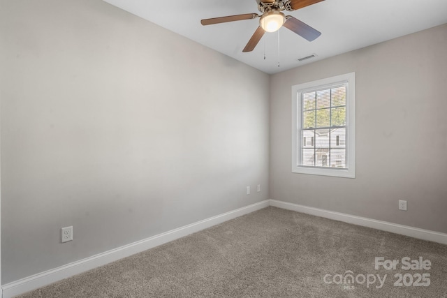 unfurnished room featuring ceiling fan, carpet, visible vents, and baseboards