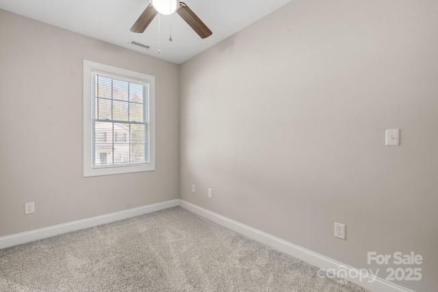 unfurnished room with visible vents, baseboards, carpet, and ceiling fan