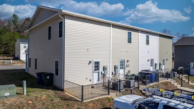 rear view of house with central air condition unit