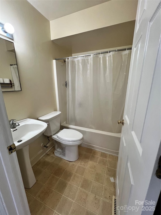 full bathroom with tile patterned floors, a sink, toilet, and shower / bath combo