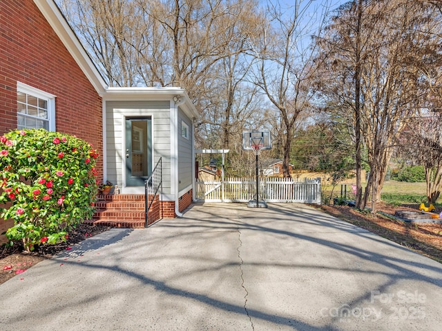 exterior space featuring entry steps and fence