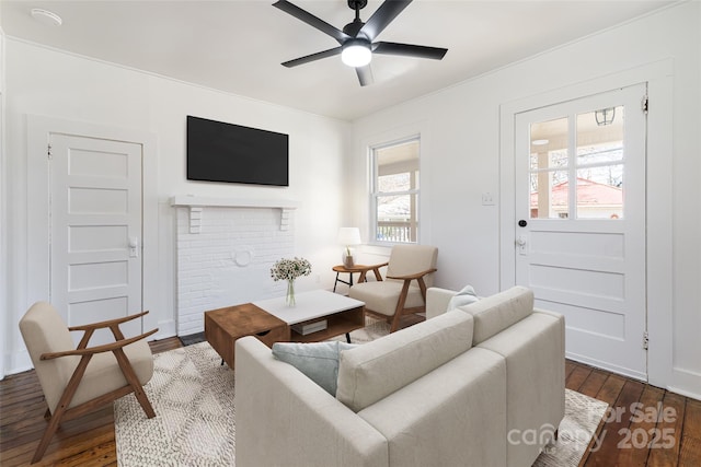 living area featuring a ceiling fan and dark wood-style floors