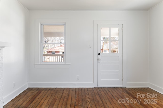 entryway featuring baseboards and dark wood-style floors