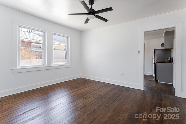 unfurnished room with baseboards, dark wood-style flooring, and ceiling fan